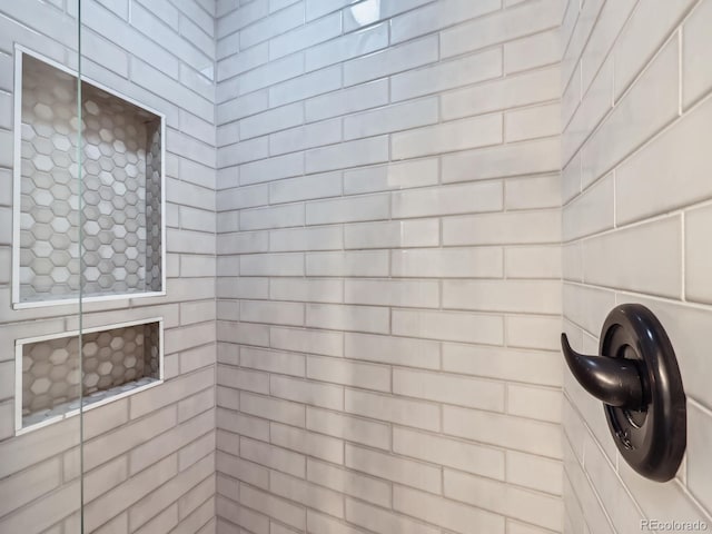 bathroom with a tile shower