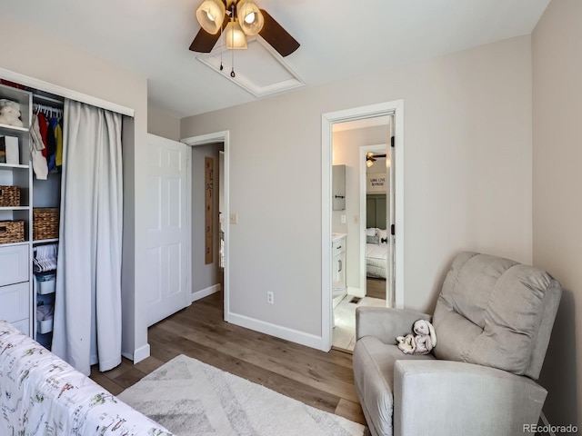 bedroom featuring ceiling fan, dark hardwood / wood-style flooring, and connected bathroom