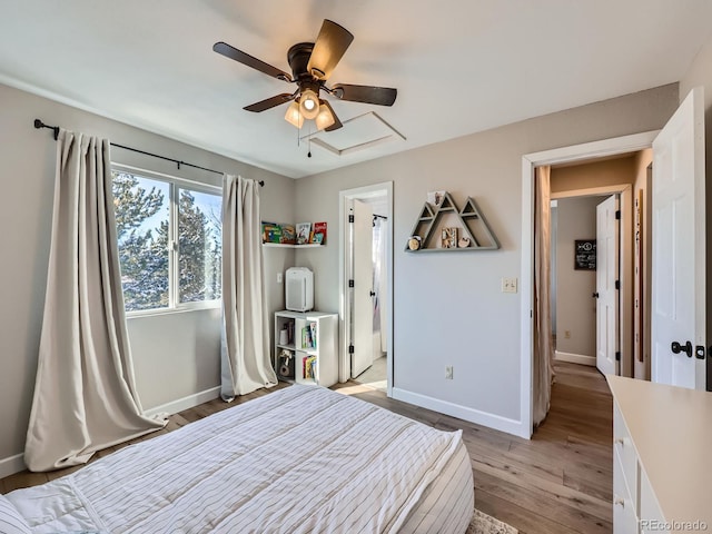 unfurnished bedroom with ensuite bath, ceiling fan, and light wood-type flooring