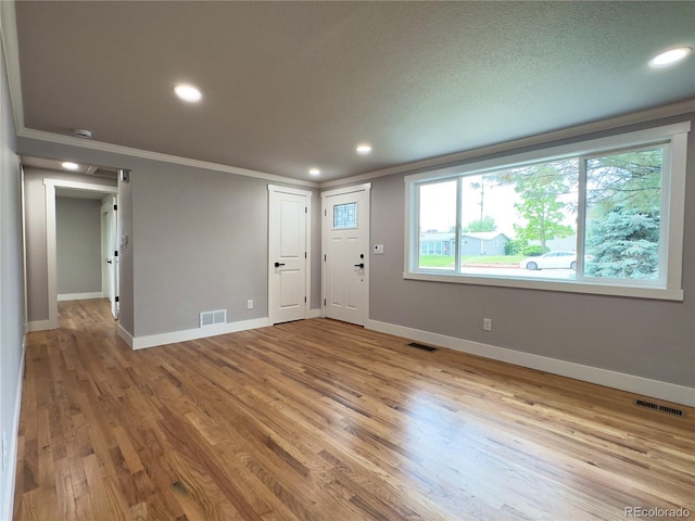 10025 W 8th Ave, Lakewood, CO 80215 - entrance foyer featuring crown molding, wood finished floors, recessed lighting, and baseboards