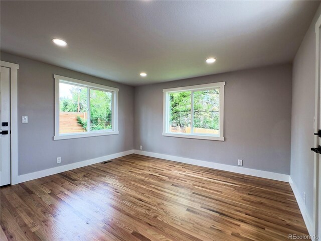 10025 W 8th Ave, Lakewood, CO 80215 - unfurnished room with wood finished floors, baseboards, and recessed lighting
