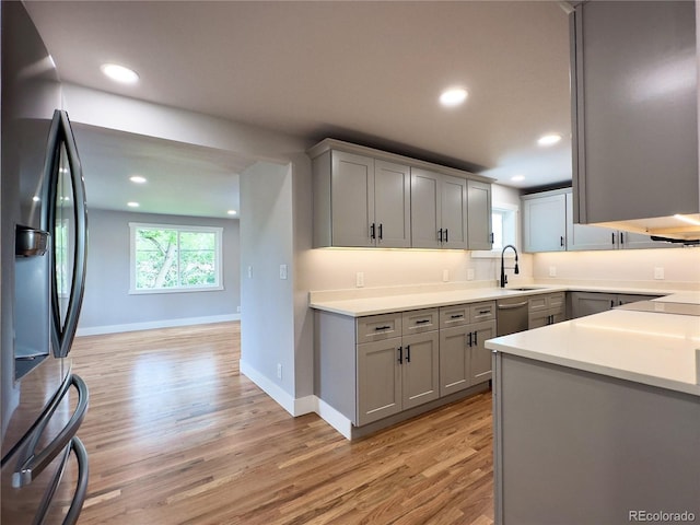 10025 W 8th Ave, Lakewood, CO 80215 - kitchen featuring appliances with stainless steel finishes, gray cabinetry, a sink, light wood-style flooring, and recessed lighting