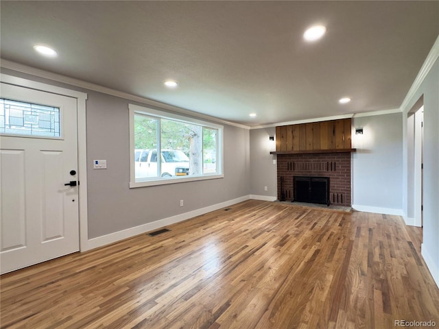 10025 W 8th Ave, Lakewood, CO 80215 - unfurnished living room with ornamental molding, recessed lighting, light wood-type flooring, baseboards, and a fireplace