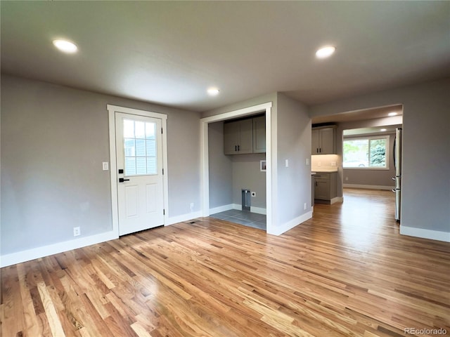 10025 W 8th Ave, Lakewood, CO 80215 - unfurnished living room with light wood finished floors, baseboards, and recessed lighting