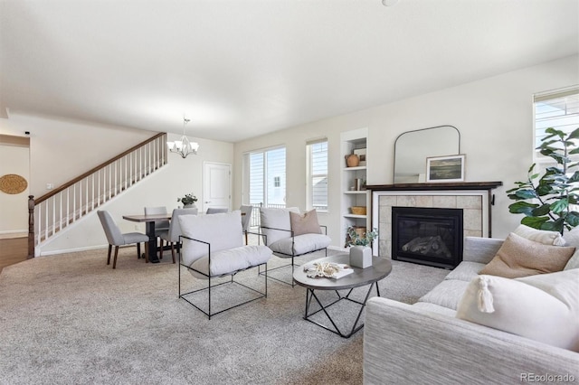 7367 S Pennsylvania St, Littleton, CO 80122 - living room featuring stairway, plenty of natural light, a chandelier, and built in shelves