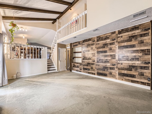 9150 Garrison St, Broomfield, CO 80021 - unfurnished living room with wood walls, stairs, baseboards, and carpet flooring