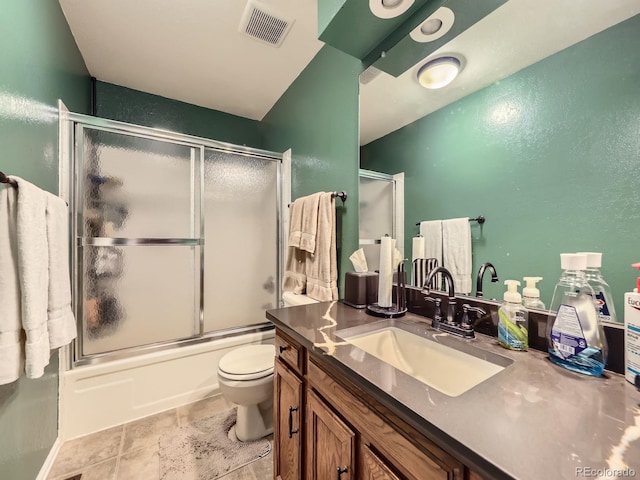 9150 Garrison St, Broomfield, CO 80021 - bathroom with vanity, toilet, combined bath / shower with glass door, a textured wall, and stone finish flooring