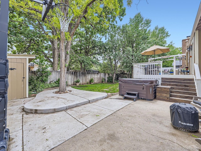 9150 Garrison St, Broomfield, CO 80021 - fenced backyard featuring a hot tub, a patio, and a wooden deck