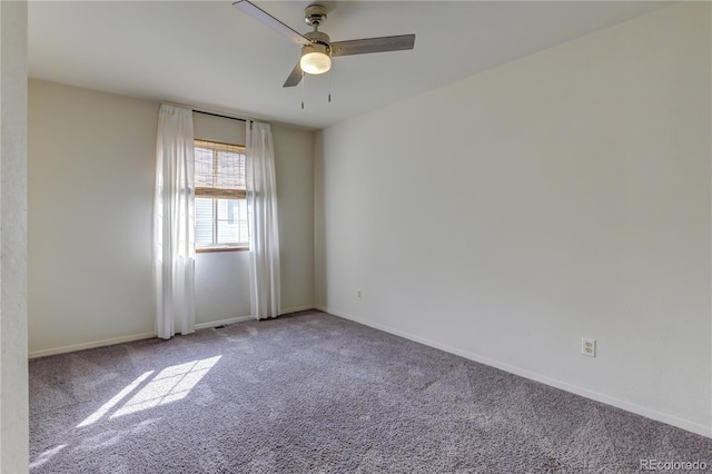 carpeted spare room with ceiling fan