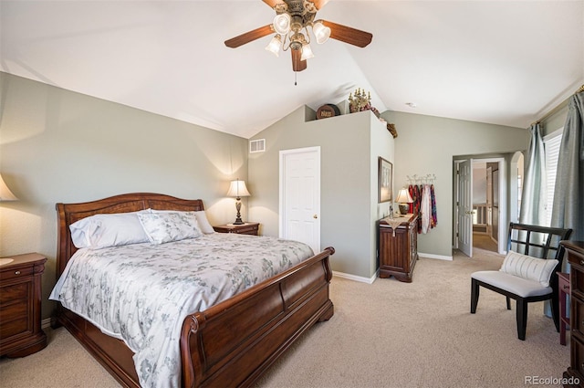 bedroom featuring vaulted ceiling, light colored carpet, and ceiling fan