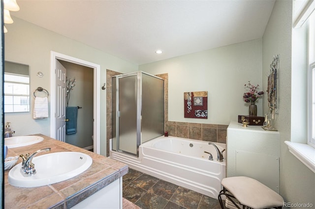 full bathroom with shower with separate bathtub, vanity, and toilet