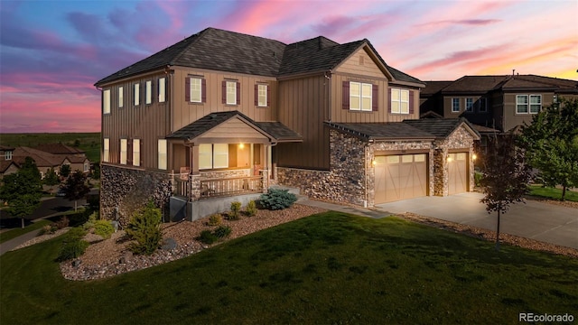 7606 S Valleyhead Ct, Aurora, CO 80016 - view of front of property with stone siding, a porch, driveway, and a front yard