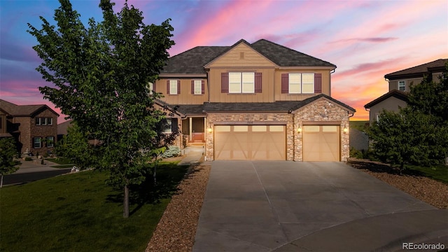 7606 S Valleyhead Ct, Aurora, CO 80016 - view of front of property with a garage, stone siding, concrete driveway, board and batten siding, and a front yard