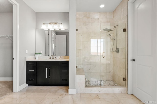 7606 S Valleyhead Ct, Aurora, CO 80016 - bathroom featuring a shower stall, vanity, marble look tile flooring, recessed lighting, and a spacious closet