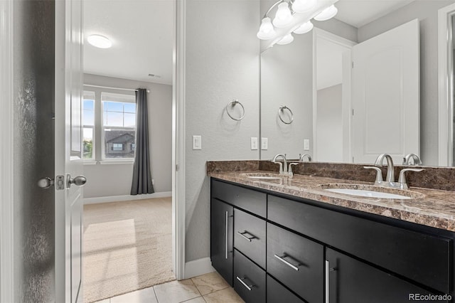 7606 S Valleyhead Ct, Aurora, CO 80016 - bathroom with double vanity, a chandelier, and a textured wall