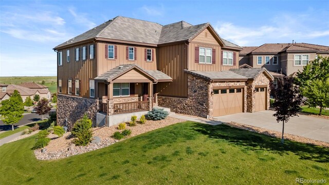 7606 S Valleyhead Ct, Aurora, CO 80016 - view of front of house with covered porch, stone siding, board and batten siding, driveway, and a front lawn