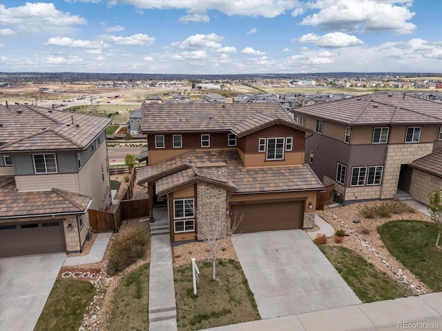 14710 Domino Dr, Parker, CO 80134 - view of front of home featuring stone siding, concrete driveway, a residential view, fence, and an attached garage