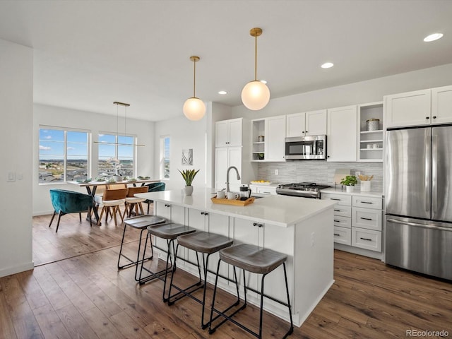 14710 Domino Dr, Parker, CO 80134 - kitchen with appliances with stainless steel finishes, open shelves, a sink, backsplash, and recessed lighting
