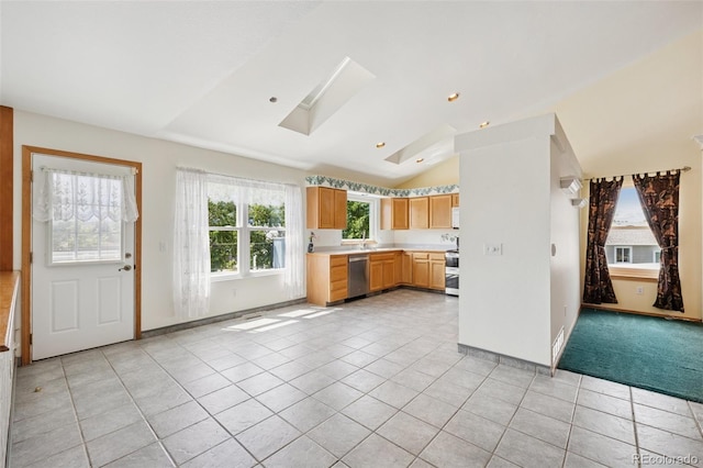 6510 Packsaddle Ct, Colorado Springs, CO 80922 - kitchen with appliances with stainless steel finishes, light tile patterned floors, lofted ceiling, light countertops, and a skylight