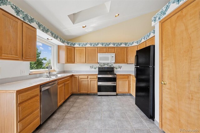 6510 Packsaddle Ct, Colorado Springs, CO 80922 - kitchen with white microwave, range with electric cooktop, freestanding refrigerator, stainless steel dishwasher, and lofted ceiling