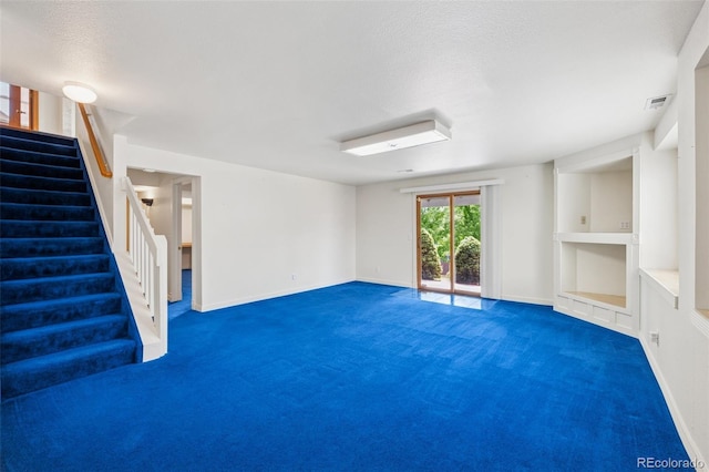 6510 Packsaddle Ct, Colorado Springs, CO 80922 - below grade area with carpet, stairs, and a textured ceiling