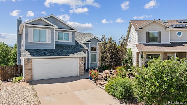 6510 Packsaddle Ct, Colorado Springs, CO 80922 - traditional-style house with concrete driveway, roof mounted solar panels, a garage, roof with shingles, and a chimney