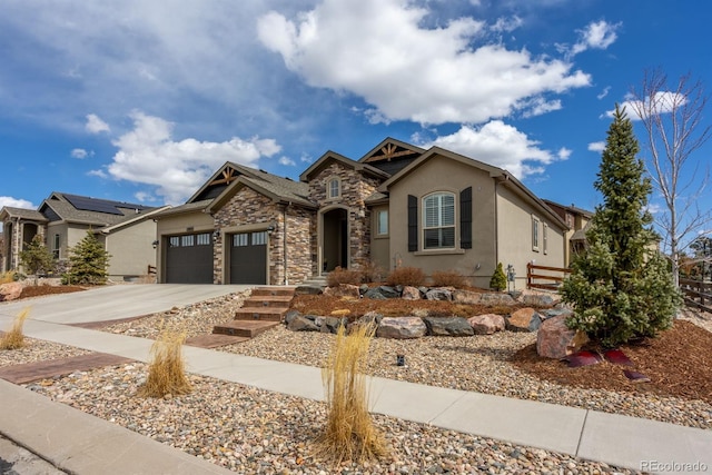 13833 Rivercrest Cir, Colorado Springs, CO 80921 - view of front of house featuring stone siding, an attached garage, stucco siding, and driveway