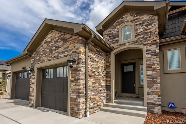 13833 Rivercrest Cir, Colorado Springs, CO 80921 - view of exterior entry featuring stone siding, an attached garage, and driveway