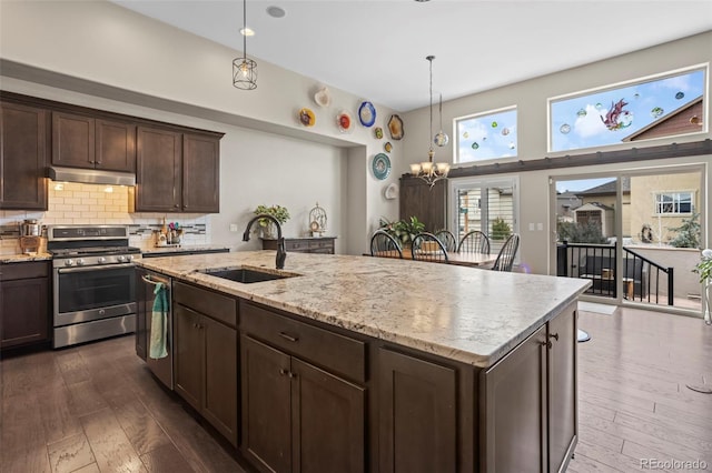 13833 Rivercrest Cir, Colorado Springs, CO 80921 - kitchen featuring stainless steel appliances, a sink, dark wood-type flooring, and under cabinet range hood