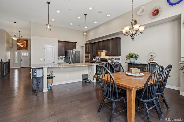 13833 Rivercrest Cir, Colorado Springs, CO 80921 - dining area featuring baseboards, dark wood-style floors, recessed lighting, a chandelier, and a towering ceiling
