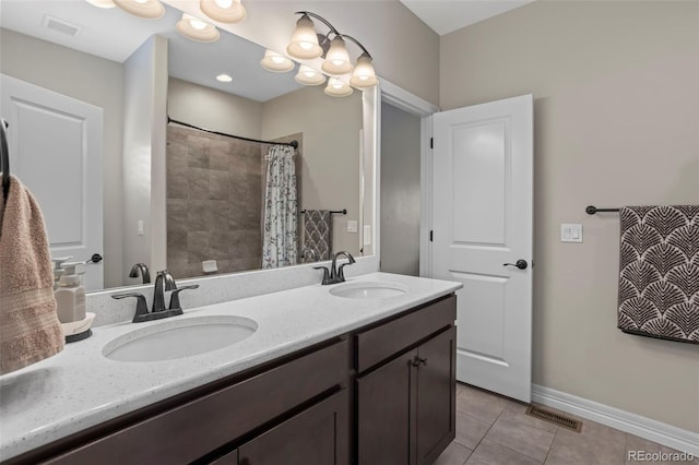 13833 Rivercrest Cir, Colorado Springs, CO 80921 - full bathroom with tile patterned floors, baseboards, double vanity, and a shower with shower curtain