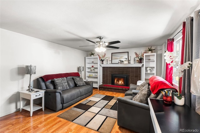 6336 W 71st Pl, Arvada, CO 80003 - living area featuring a ceiling fan, light wood-type flooring, and a fireplace