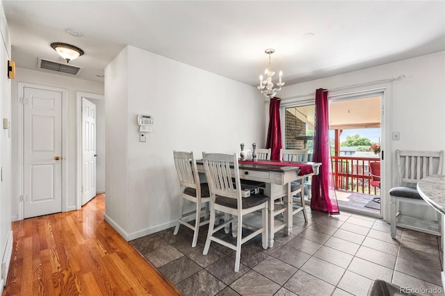 6336 W 71st Pl, Arvada, CO 80003 - dining area with a chandelier and baseboards