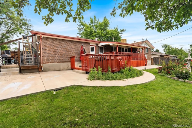 6336 W 71st Pl, Arvada, CO 80003 - rear view of property with a wooden deck, brick siding, and a patio