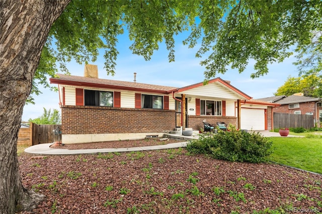 6336 W 71st Pl, Arvada, CO 80003 - ranch-style house featuring brick siding, a chimney, an attached garage, and concrete driveway
