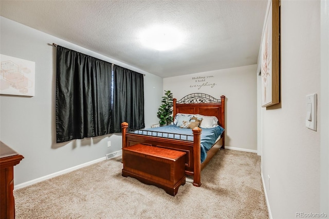 carpeted bedroom featuring a textured ceiling