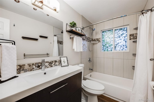 full bathroom with shower / bath combo with shower curtain, hardwood / wood-style flooring, toilet, and vanity