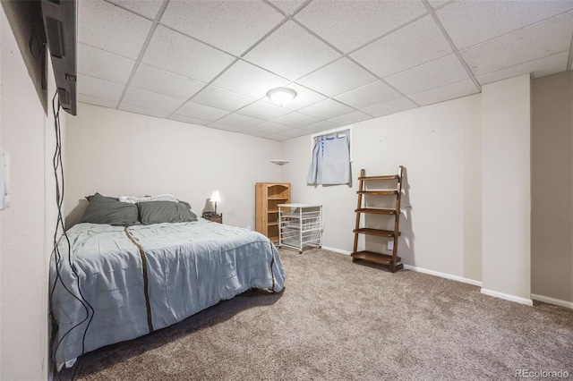 bedroom with carpet floors and a drop ceiling