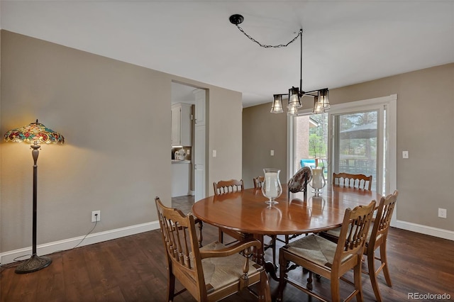 1540 Fawnwood Rd, Monument, CO 80132 - dining area with baseboards, dark wood-style flooring, and a chandelier