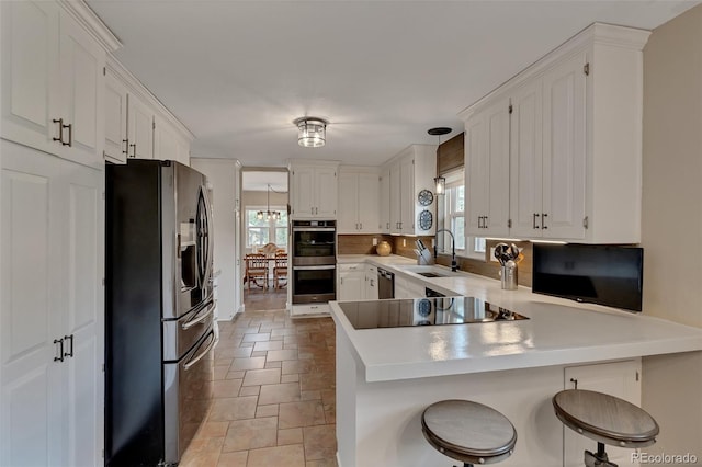 1540 Fawnwood Rd, Monument, CO 80132 - kitchen with black appliances, a sink, plenty of natural light, and a peninsula