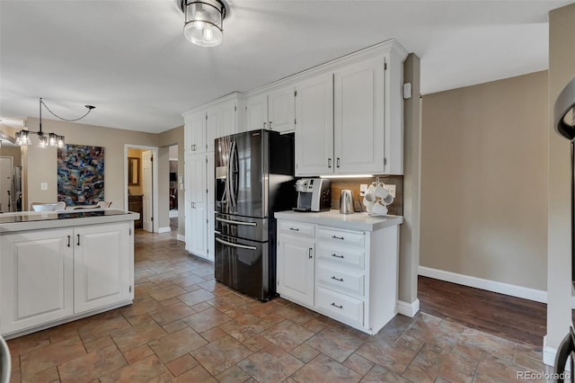 1540 Fawnwood Rd, Monument, CO 80132 - kitchen featuring stainless steel refrigerator with ice dispenser, light stone finish flooring, baseboards, and white cabinets