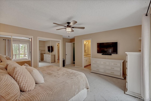 1540 Fawnwood Rd, Monument, CO 80132 - bedroom with light colored carpet, ensuite bath, a textured ceiling, and a ceiling fan