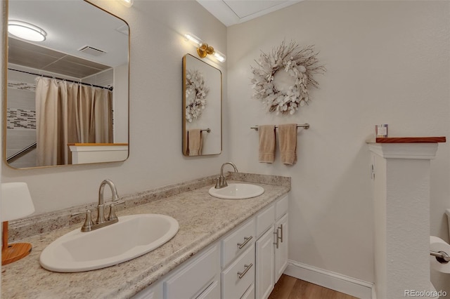 1540 Fawnwood Rd, Monument, CO 80132 - full bathroom with double vanity, wood finished floors, and baseboards