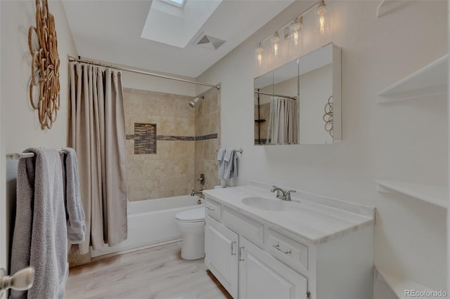 1540 Fawnwood Rd, Monument, CO 80132 - full bath featuring a skylight, vanity, toilet, shower / tub combo with curtain, and wood finished floors