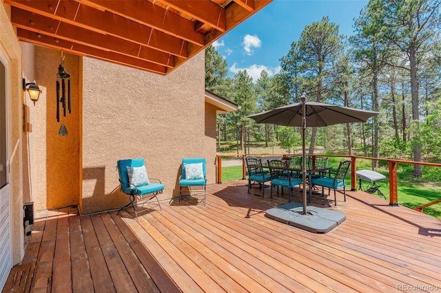 1540 Fawnwood Rd, Monument, CO 80132 - deck with outdoor dining area and view of wooded area