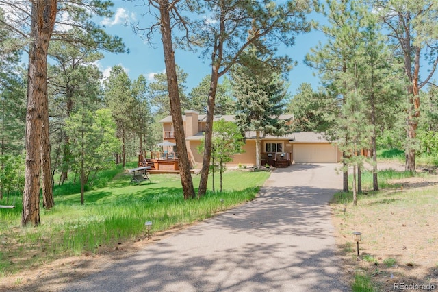 1540 Fawnwood Rd, Monument, CO 80132 - view of front of house featuring driveway, stucco siding, a garage, and a front yard