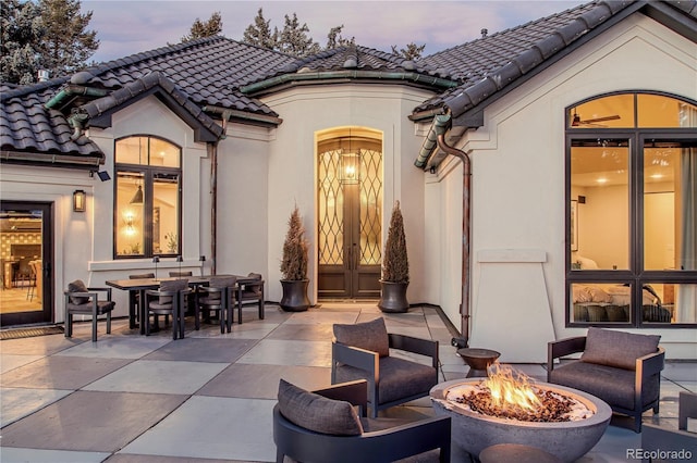 exterior space featuring french doors and an outdoor fire pit