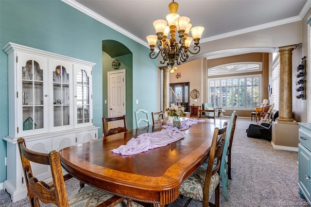 carpeted dining space with crown molding, ornate columns, arched walkways, and a notable chandelier