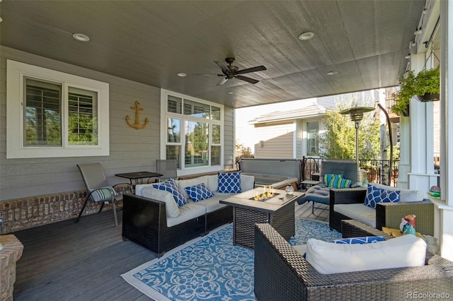 view of patio featuring an outdoor living space with a fire pit, a ceiling fan, and a wooden deck