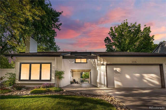 3235 E Easter Pl, Centennial, CO 80122 - view of front of home featuring a garage, driveway, and a chimney